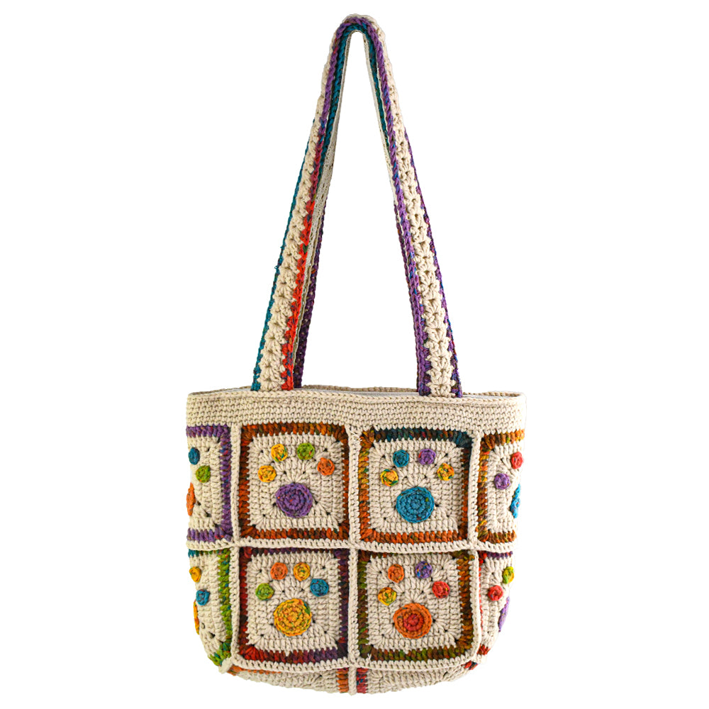 Handmade crochet tote bag with colorful floral and paw patterns, featuring a beige base and multicolor woven straps. Lightweight and spacious, perfect for casual outings or daily use.