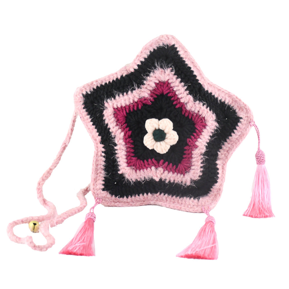 Handmade star-shaped crochet bag in pink and black with three pink tassels, white flower center, and braided shoulder strap
