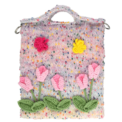 Handwoven knit bag with pink 3D flowers and green leaves, featuring a colorful dotted background, soft and durable, ideal for daily use or decoration.