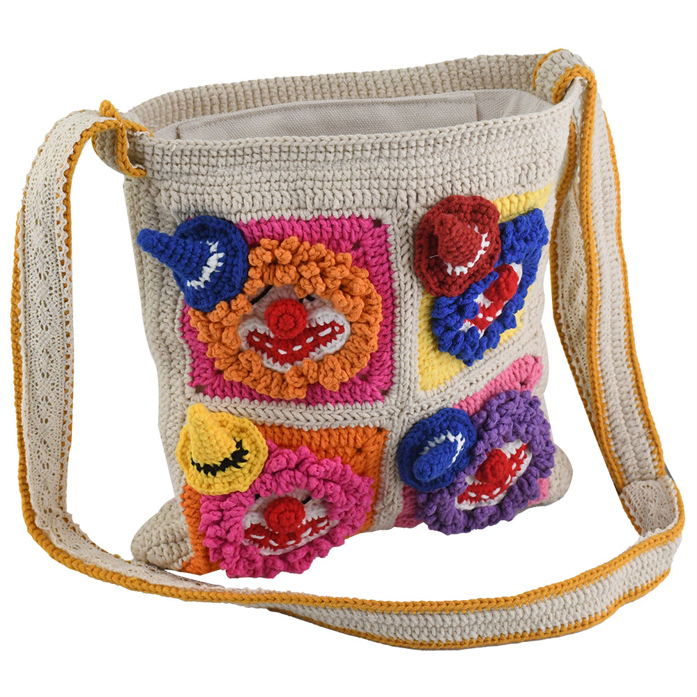 Handmade crochet shoulder bag with colorful 3D clown face patterns, featuring a beige base and vibrant multicolored details. Lightweight, artistic, and perfect for casual outings or as a unique gift.