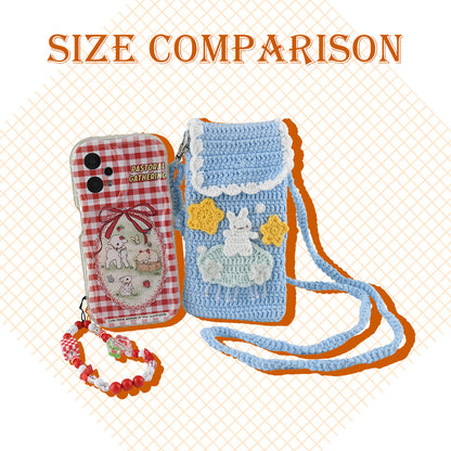 Handmade crochet phone crossbody bag in baby blue with white bunny on mint cloud applique and yellow stars, featuring scalloped white trim and braided strap
