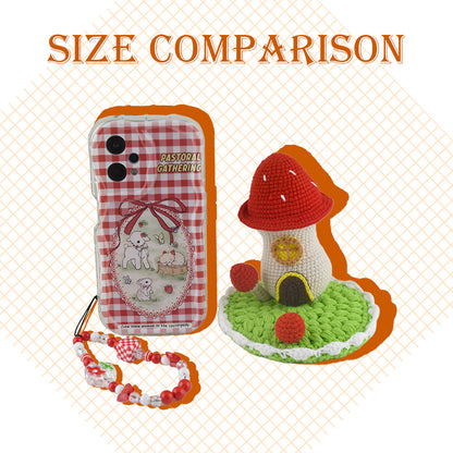 Decorative crochet toadstool cottage featuring bright red cap with white dots, beige body, and green circular base
