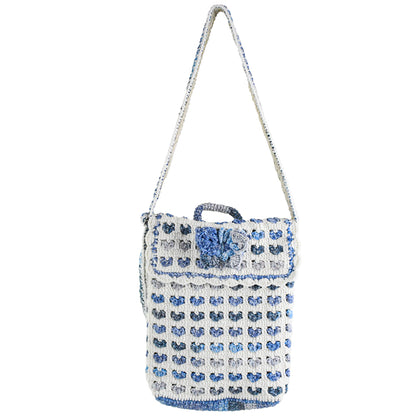 Handmade crochet shoulder bag with a unique blue and white floral pattern, featuring an adjustable strap and secure flap closure. Lightweight and perfect for everyday use.