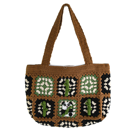 Handmade crochet patchwork bag with a brown base, black, green, and white patterns, featuring a panda and bamboo design in the center. Vintage style, eco-friendly, and lightweight, ideal for shopping or daily use.