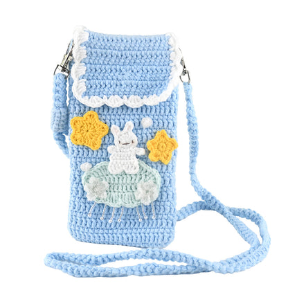 Handmade crochet phone crossbody bag in baby blue with white bunny on mint cloud applique and yellow stars, featuring scalloped white trim and braided strap
