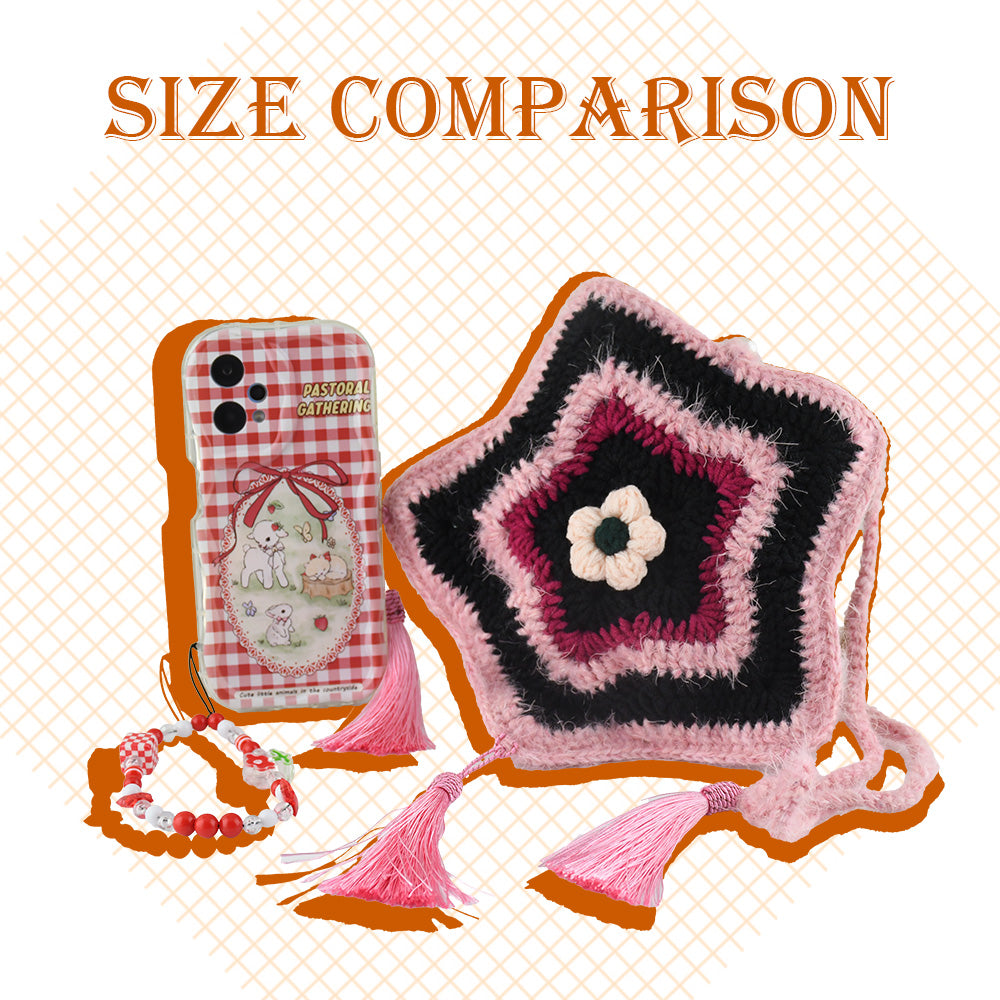 Handmade star-shaped crochet bag in pink and black with three pink tassels, white flower center, and braided shoulder strap
