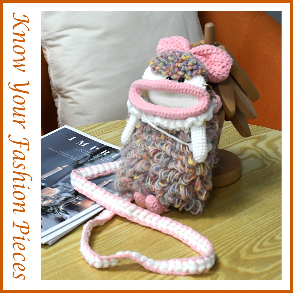 Handcrafted pink crochet doll crossbody phone pouch with zipper closure and cute facial details
