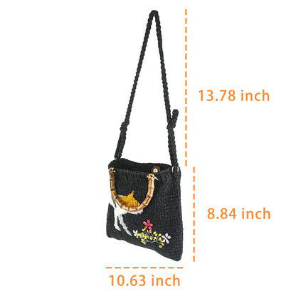 Handmade knitted black tote bag featuring a bamboo handle, embroidered cat design, and colorful floral accents. Lightweight and eco-friendly, perfect for casual or creative fashion styles.