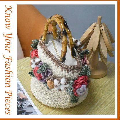 Handwoven cotton tote bag with bamboo handles, decorated with crochet flowers in pink, coral, purple and white cotton blooms, natural beige base
