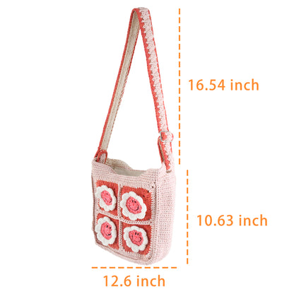 Handmade pink crochet bag with red and white floral square patterns, featuring a top handle. Perfect for casual outings or shopping