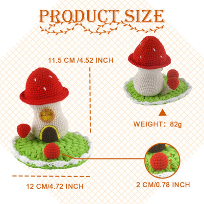 Decorative crochet toadstool cottage featuring bright red cap with white dots, beige body, and green circular base
