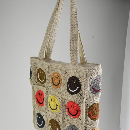 Handmade crochet tote bag with colorful smiley face patterns, featuring a beige base and sturdy knitted straps. Lightweight and spacious, perfect for casual outings, shopping, or daily use.