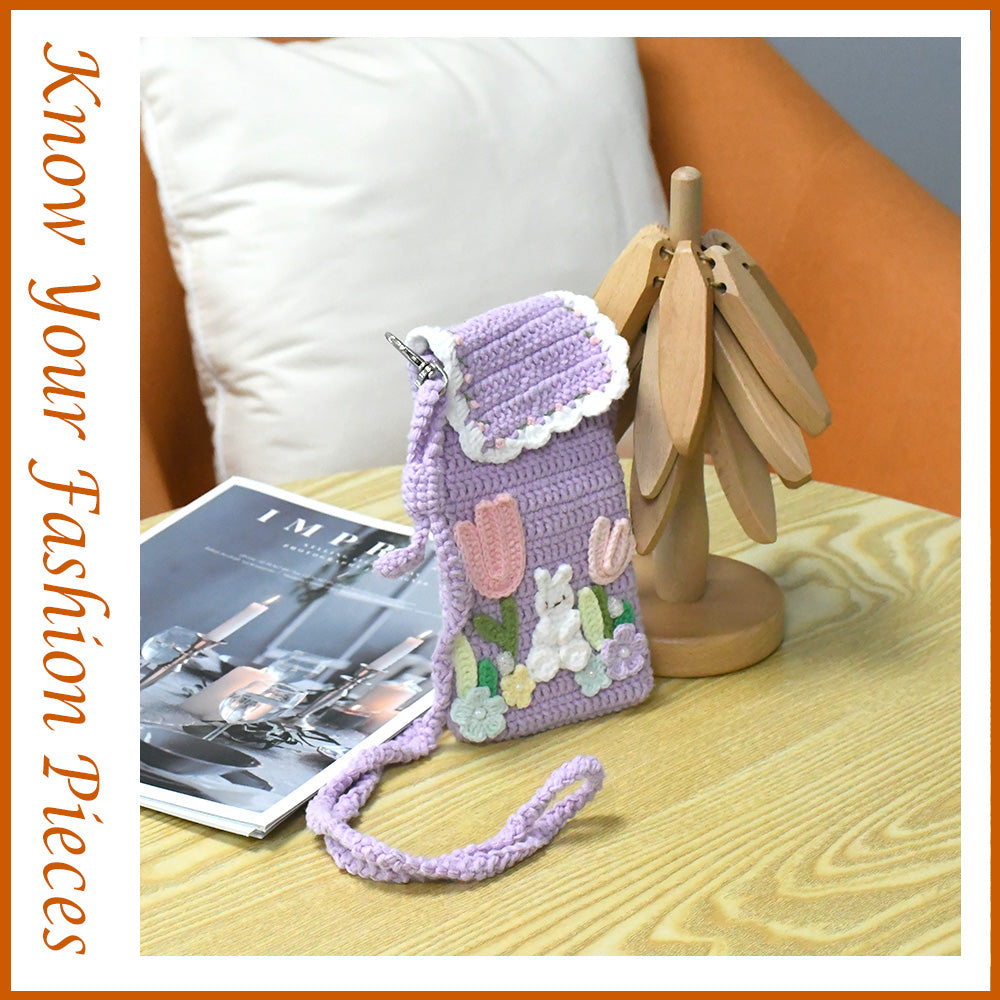 Purple crochet phone pouch with pink tulips, white bunny, and pastel flowers, featuring braided shoulder strap
