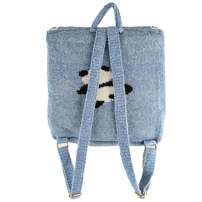 Hand-knitted blue panda backpack with a cute panda design lying on a branch and a small red heart embroidered on the flap. Lightweight and perfect for casual use.