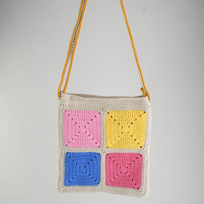 Handmade crochet shoulder bag with colorful 3D clown face patterns, featuring a beige base and vibrant multicolored details. Lightweight, artistic, and perfect for casual outings or as a unique gift.