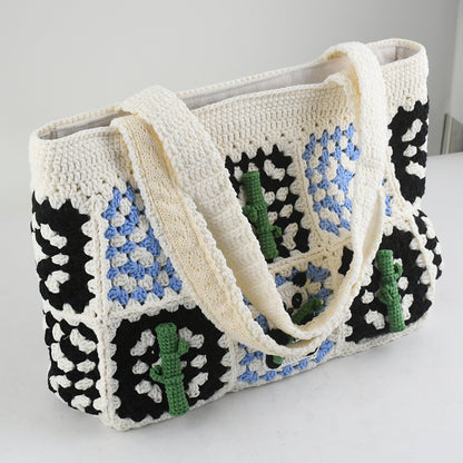 Handmade crochet tote bag featuring a panda design with bamboo patterns, blue and black square details, and a soft white base. Perfect for casual outings or eco-friendly shopping.