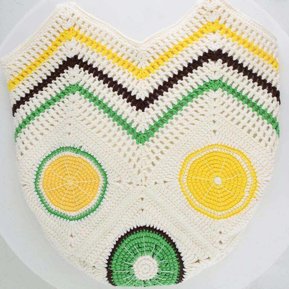 Handmade crochet tote bag with vibrant citrus patterns, featuring a beige base and colorful yellow, green, and brown details. Lightweight, eco-friendly, and perfect for summer beach outings or daily use.