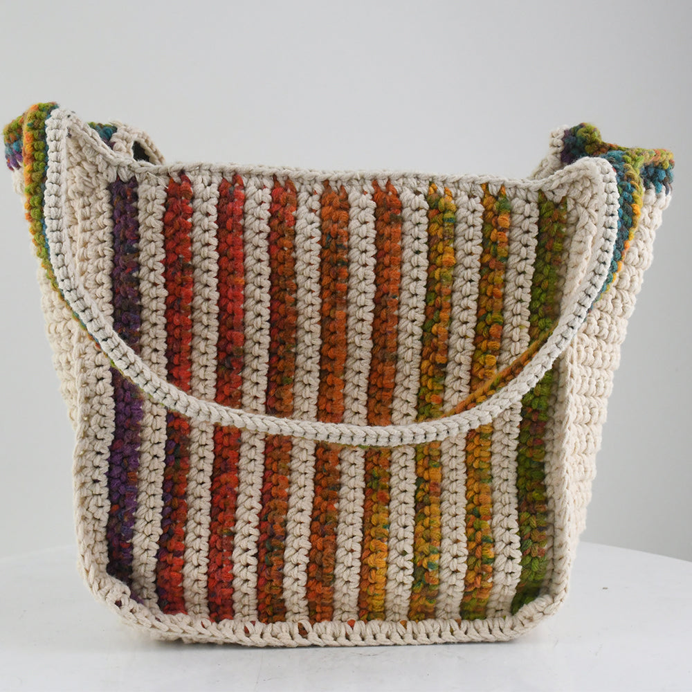 Handmade crochet tote bag featuring a natural cream base with colorful rainbow stripes. The bag has a spacious design with matching rainbow-accented shoulder straps, perfect for casual outings, shopping, or beach trips