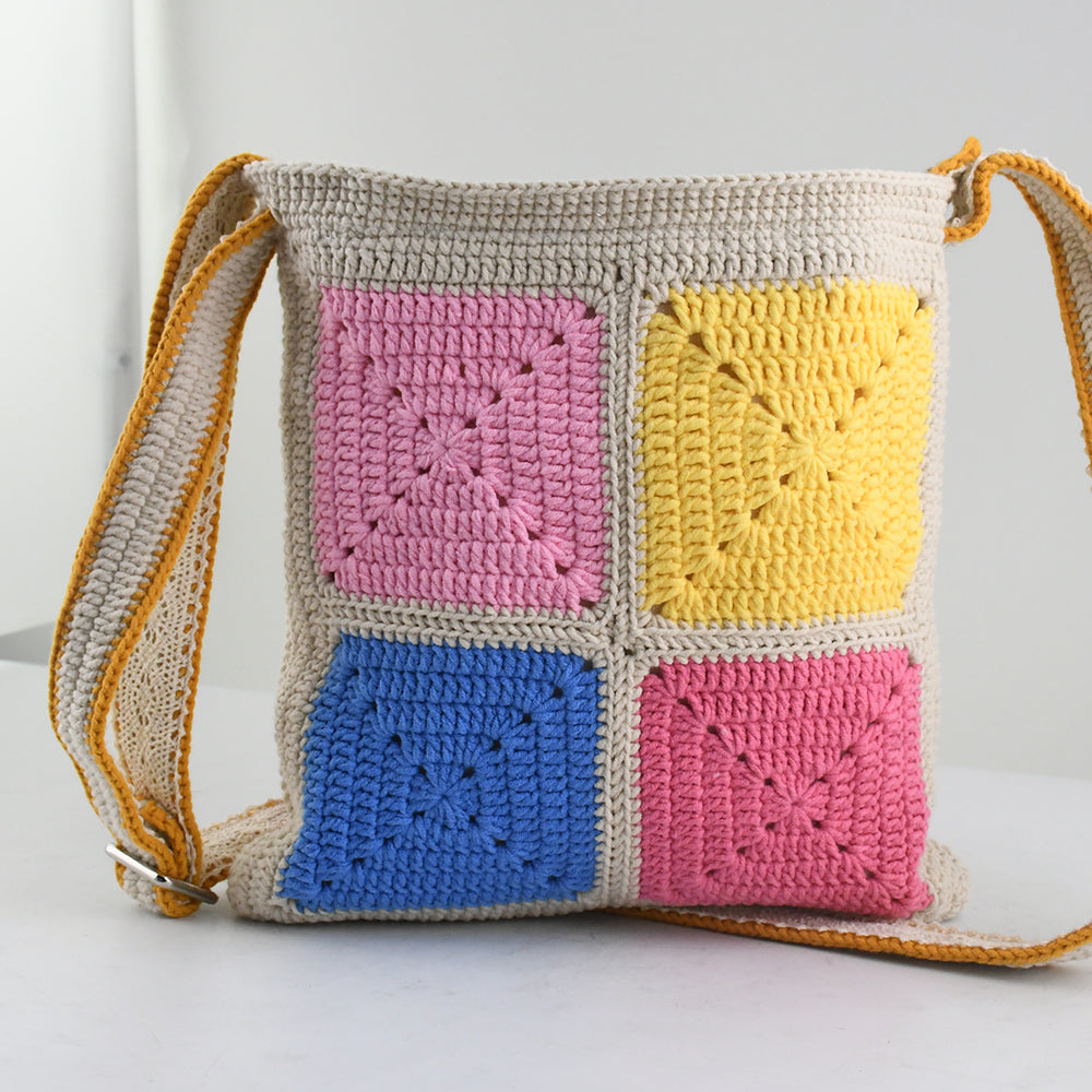 Handmade crochet shoulder bag with colorful 3D clown face patterns, featuring a beige base and vibrant multicolored details. Lightweight, artistic, and perfect for casual outings or as a unique gift.