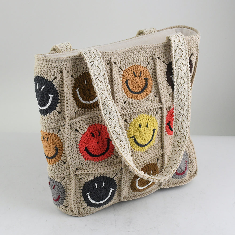 Handmade crochet tote bag with colorful smiley face patterns, featuring a beige base and sturdy knitted straps. Lightweight and spacious, perfect for casual outings, shopping, or daily use.