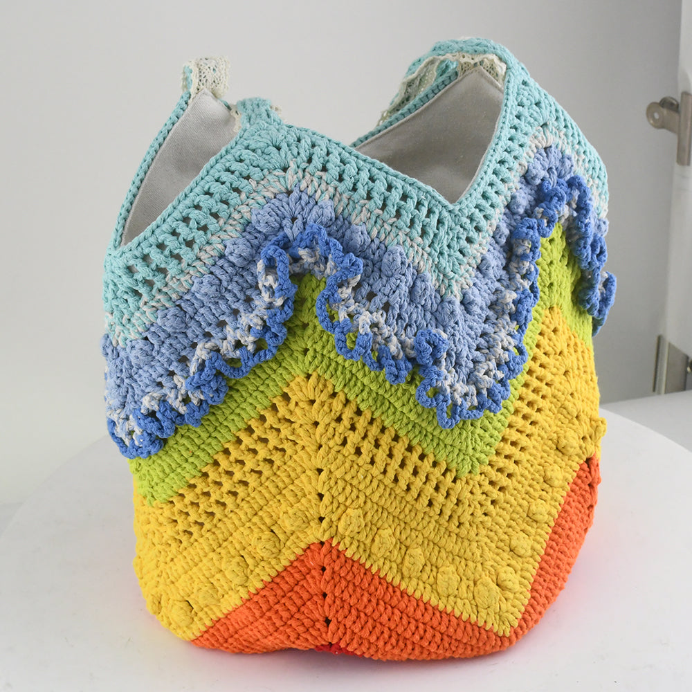 Handmade crochet tote bag with a vibrant rainbow wave pattern. Features eco-friendly yarn, spacious design, and soft fabric handles. Perfect for shopping, beach trips, or casual outings