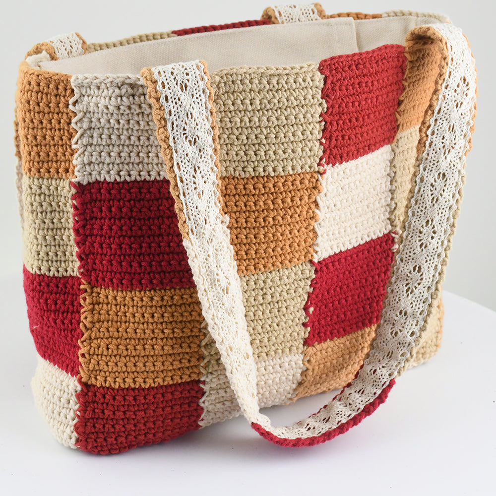 Handcrafted crochet tote bag with a checkered pattern in warm tones of red, beige, orange, and cream. Lightweight, durable, and spacious, perfect for daily use or shopping trips.