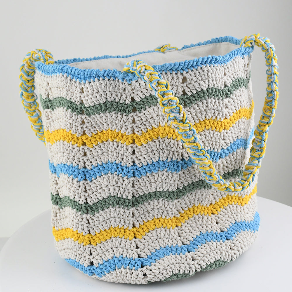 Handwoven crochet tote bag with colorful wave patterns in blue, yellow, green, and cream. Features a braided handle and lightweight, eco-friendly design. Perfect for everyday use, shopping, or beach trips.