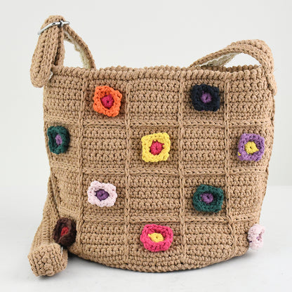 Handmade crochet shoulder bag with a beige base and colorful 3D floral square patterns. Features a soft adjustable strap and spacious interior, perfect for daily use, shopping, or travel.