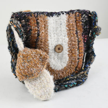 Handmade crochet crossbody bag with earthy tones, featuring a unique mushroom charm, semi-circle flap design, and durable woven strap. Lightweight and eco-friendly, perfect for boho and vintage-inspired styles.