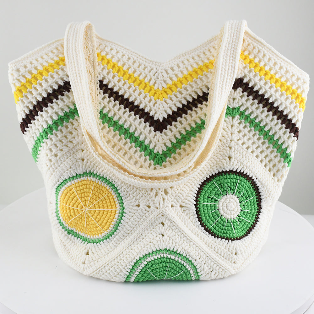 Handmade crochet tote bag with vibrant citrus patterns, featuring a beige base and colorful yellow, green, and brown details. Lightweight, eco-friendly, and perfect for summer beach outings or daily use.