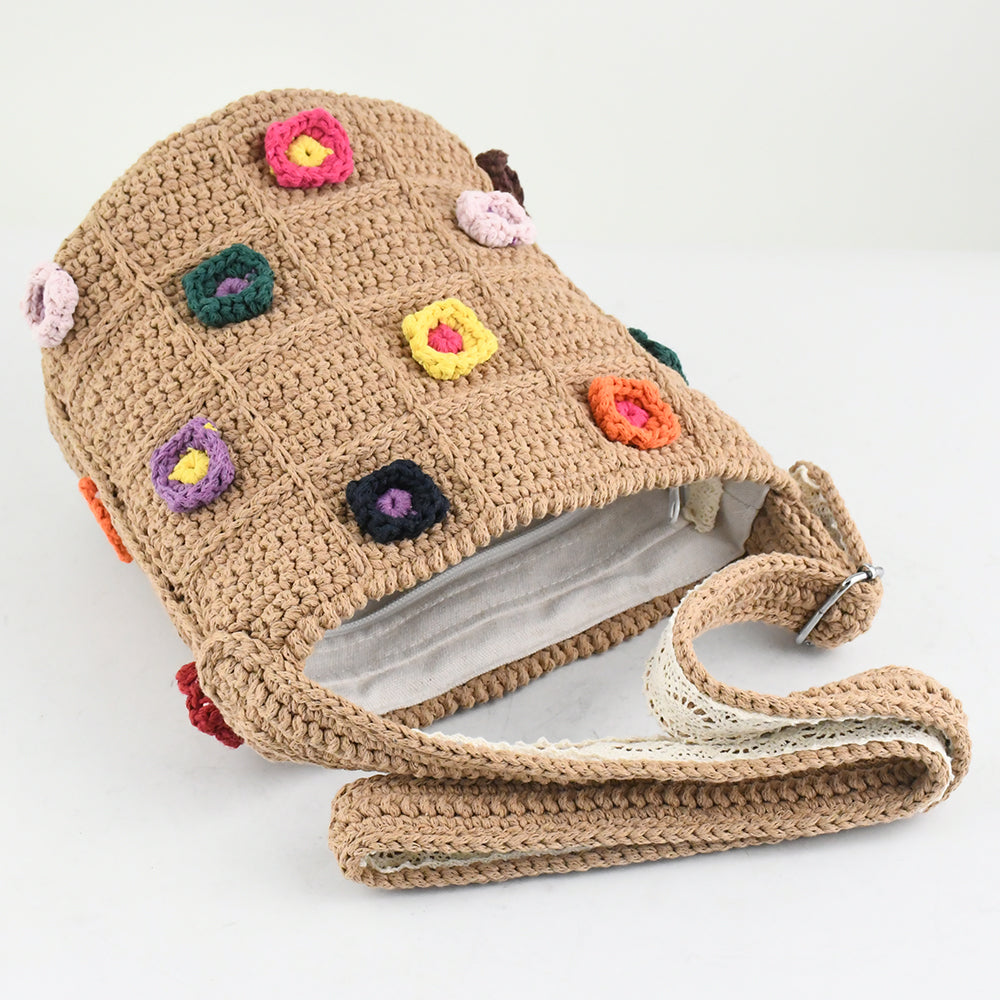 Handmade crochet shoulder bag with a beige base and colorful 3D floral square patterns. Features a soft adjustable strap and spacious interior, perfect for daily use, shopping, or travel.