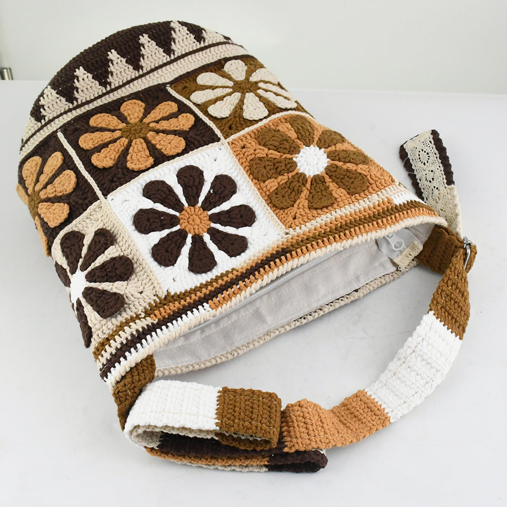 Handmade crochet shoulder bag with retro floral square patterns in earthy tones of brown, beige, and white. Features a long adjustable strap and a spacious bucket-style design, perfect for casual outings or shopping.