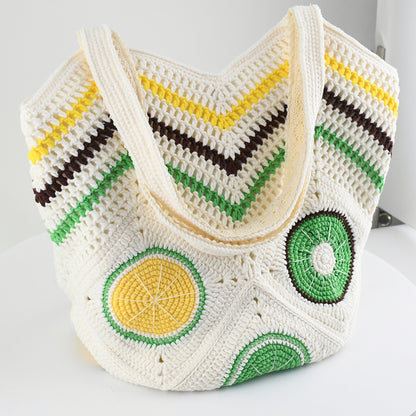 Handmade crochet tote bag with vibrant citrus patterns, featuring a beige base and colorful yellow, green, and brown details. Lightweight, eco-friendly, and perfect for summer beach outings or daily use.