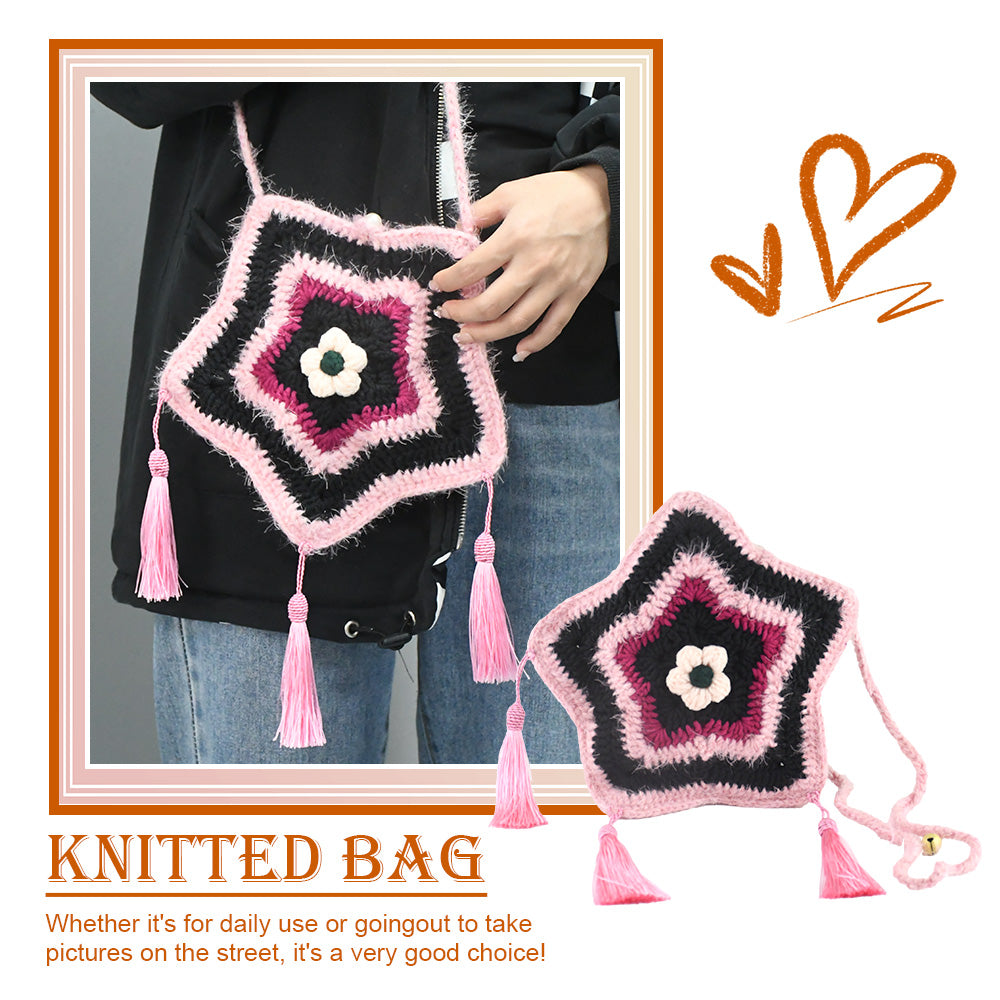 Handmade star-shaped crochet bag in pink and black with three pink tassels, white flower center, and braided shoulder strap
