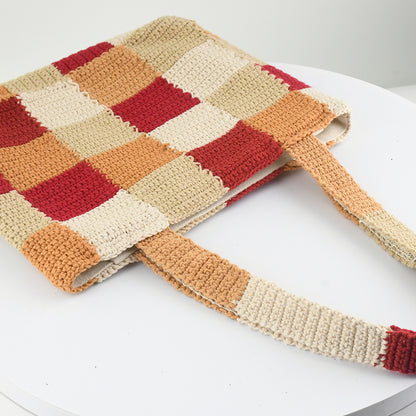 Handcrafted crochet tote bag with a checkered pattern in warm tones of red, beige, orange, and cream. Lightweight, durable, and spacious, perfect for daily use or shopping trips.