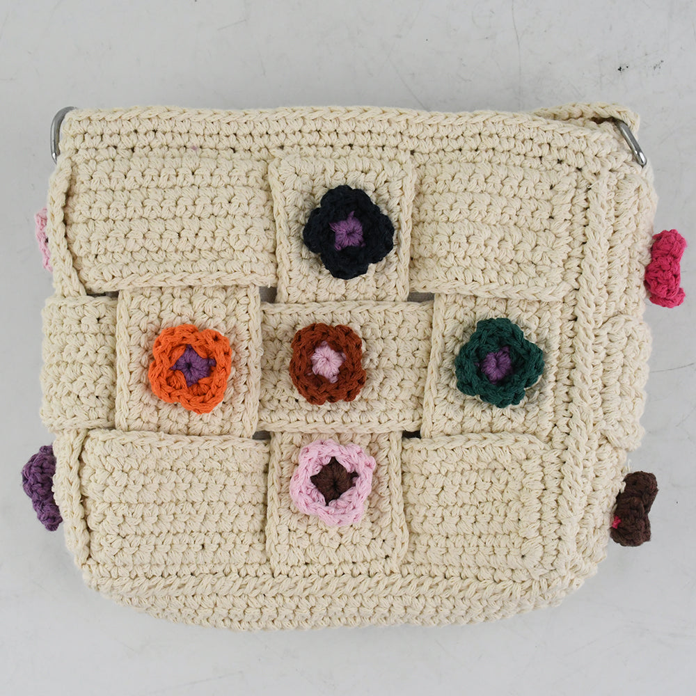 Handmade crochet shoulder bag with beige base and colorful floral accents, featuring a woven adjustable strap and a unique patchwork design. Lightweight and perfect for casual outings or daily use.