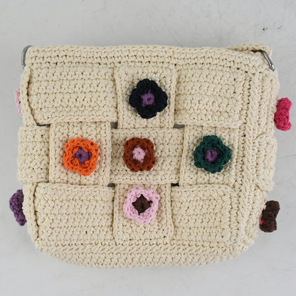 Handmade crochet shoulder bag with beige base and colorful floral accents, featuring a woven adjustable strap and a unique patchwork design. Lightweight and perfect for casual outings or daily use.