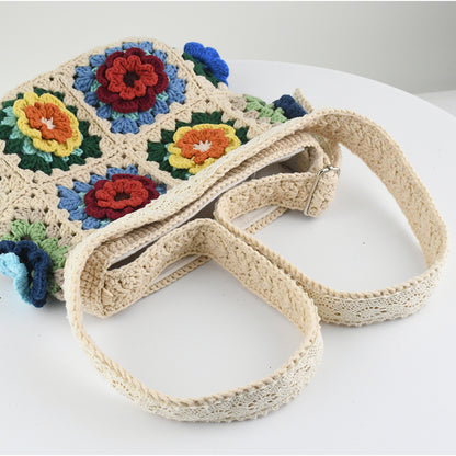 Handmade crochet tote bag featuring a colorful 3D floral design. Beige base with red, blue, green, and yellow flower accents. Lightweight, spacious, and perfect for shopping or casual outings.