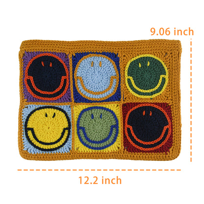 Handmade crochet clutch bag featuring colorful smiling face motifs in pink, yellow, blue, green, red, and orange squares. Lightweight, eco-friendly, and compact design with a secure zipper closure.