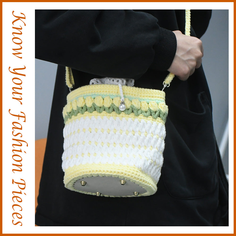 Handmade crochet bucket bag in white and yellow with pearl details, drawstring closure and adjustable shoulder strap
