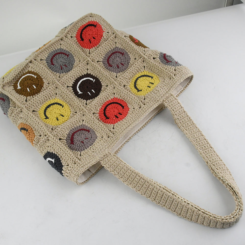 Handmade crochet tote bag with colorful smiley face patterns, featuring a beige base and sturdy knitted straps. Lightweight and spacious, perfect for casual outings, shopping, or daily use.