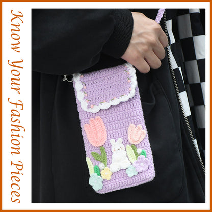 Purple crochet phone pouch with pink tulips, white bunny, and pastel flowers, featuring braided shoulder strap
