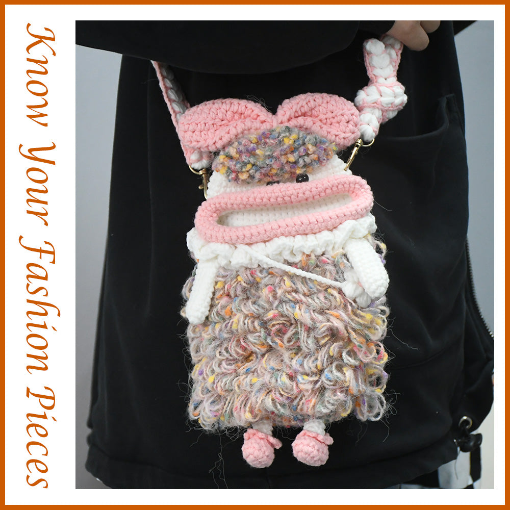 Handcrafted pink crochet doll crossbody phone pouch with zipper closure and cute facial details
