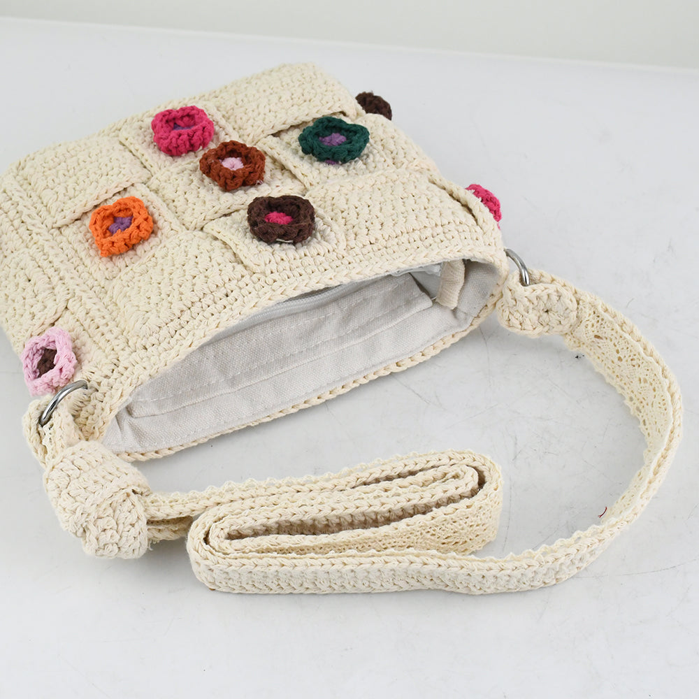 Handmade crochet shoulder bag with beige base and colorful floral accents, featuring a woven adjustable strap and a unique patchwork design. Lightweight and perfect for casual outings or daily use.