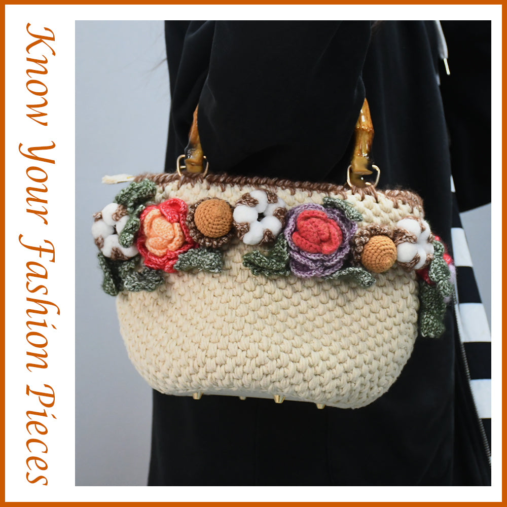 Handwoven cotton tote bag with bamboo handles, decorated with crochet flowers in pink, coral, purple and white cotton blooms, natural beige base

