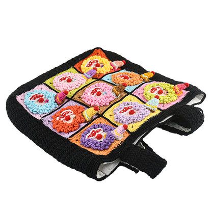 Handmade black crochet tote bag featuring colorful 3D clown patchwork squares, with a lightweight and durable design. Perfect for shopping, daily use, or gifting.