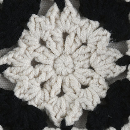 Handmade crochet crossbody bag with a black and white patchwork design, featuring square floral patterns, an adjustable strap, and a soft, lightweight texture.