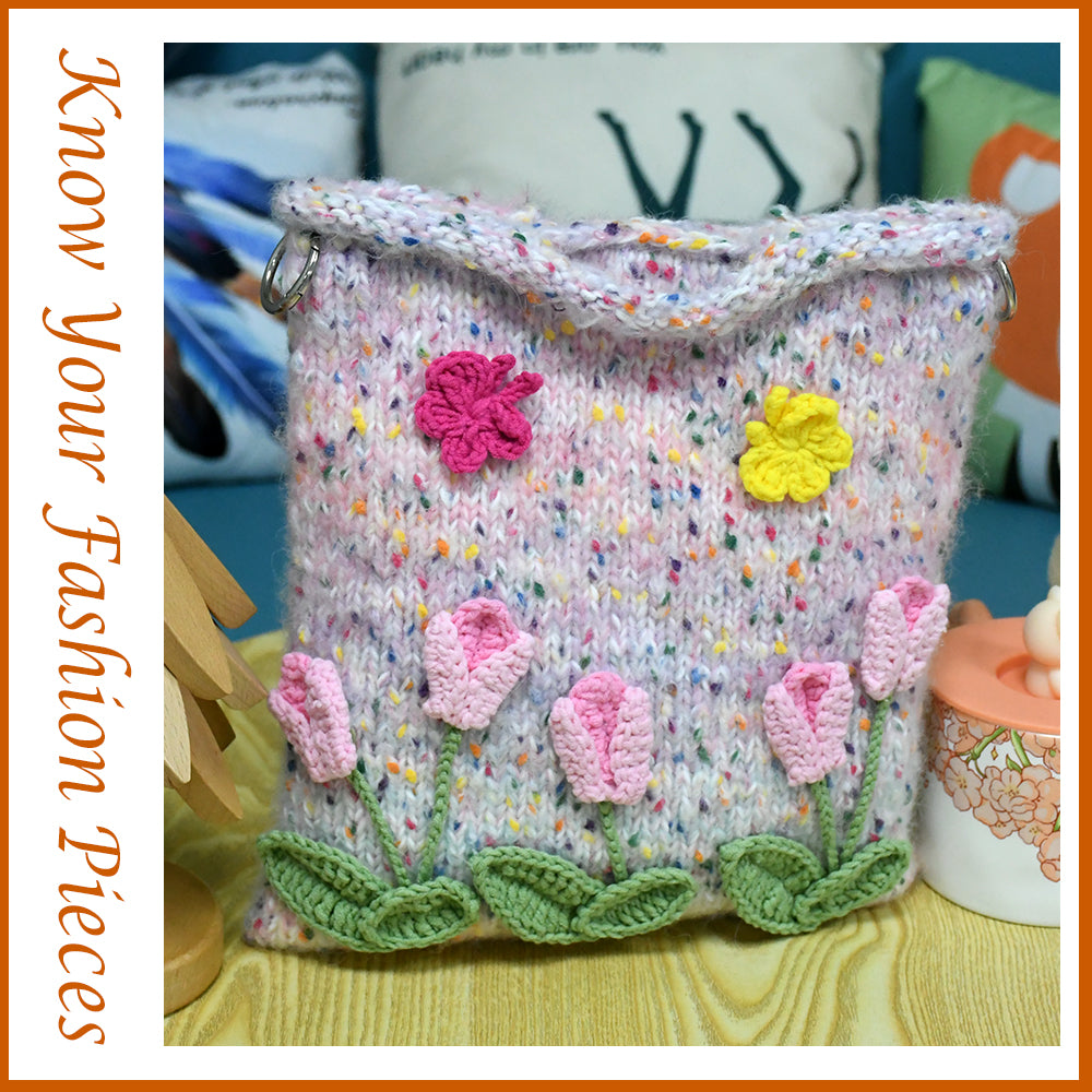 Handwoven knit bag with pink 3D flowers and green leaves, featuring a colorful dotted background, soft and durable, ideal for daily use or decoration.