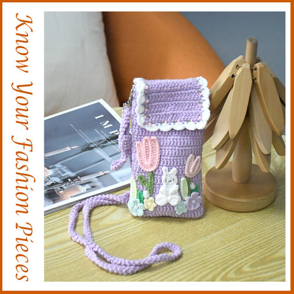 Purple crochet phone pouch with pink tulips, white bunny, and pastel flowers, featuring braided shoulder strap
