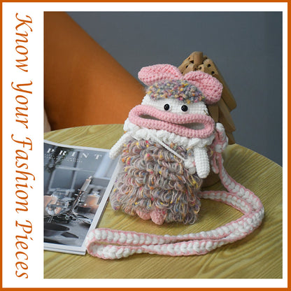 Handcrafted pink crochet doll crossbody phone pouch with zipper closure and cute facial details
